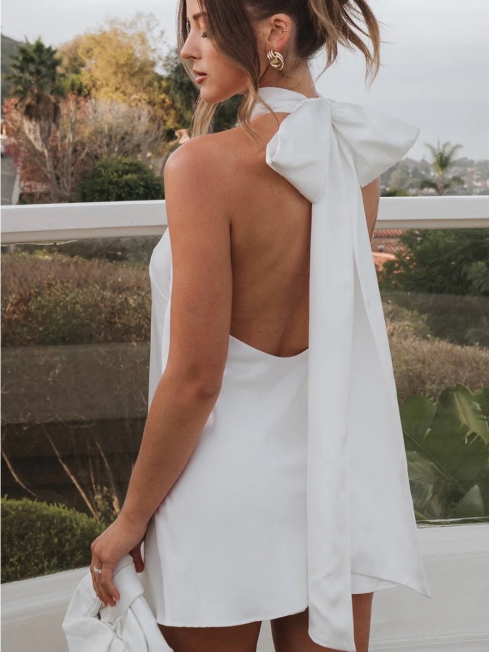 Open-Back White Halter Mini Dress with Bow Tie